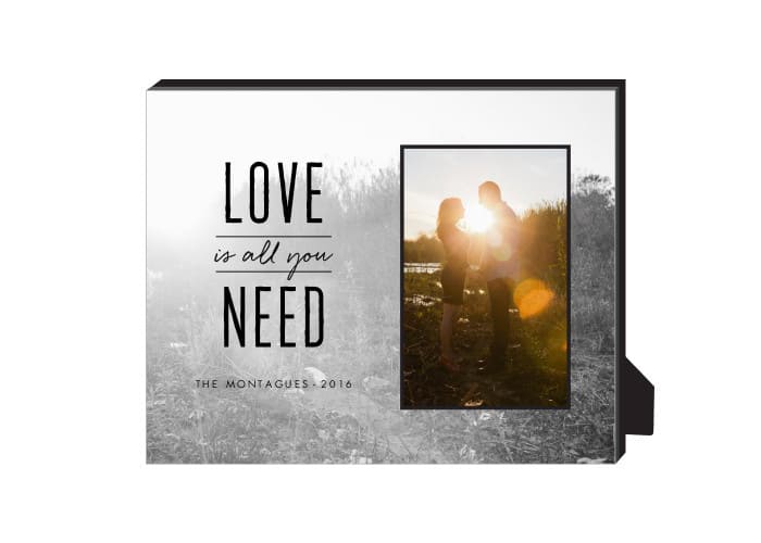 A personalized frame that says "love is all we need. "