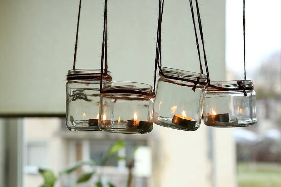 DIY candles in glass jars hanging on linen jute.