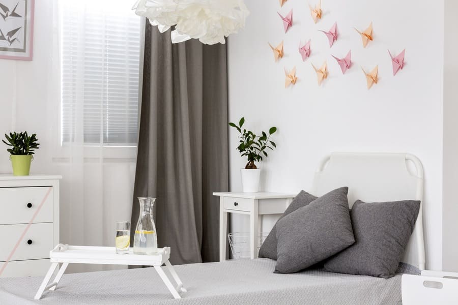White bedroom with grey details and origami wall decor
